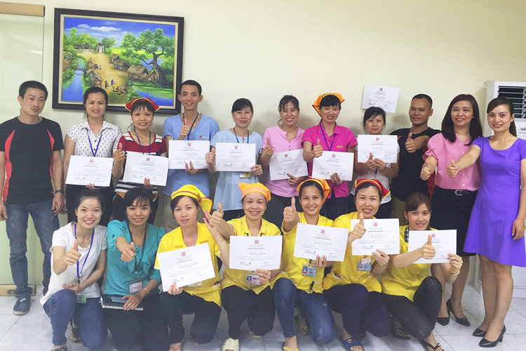 Members of the committee holding their certificate of completion for one of the trainings held near Hanoi, Vietnam. 